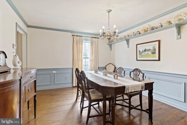 dining space featuring a chandelier, crown molding, and dark hardwood / wood-style flooring