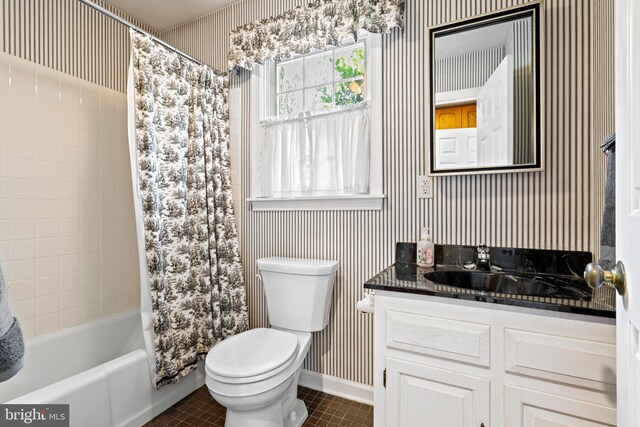 full bathroom with shower / bath combo with shower curtain, toilet, tile patterned flooring, and vanity