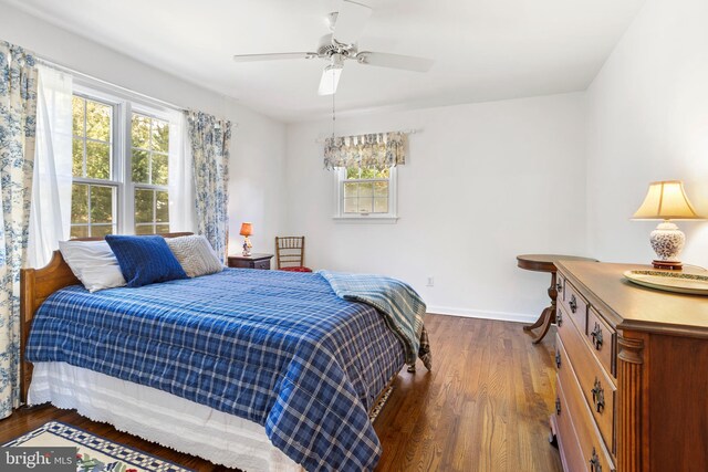 bedroom with ceiling fan and dark hardwood / wood-style floors