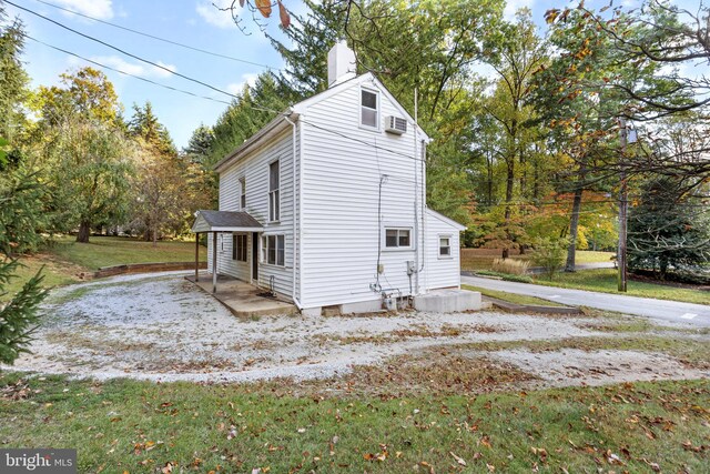 view of property exterior featuring a yard and a patio area