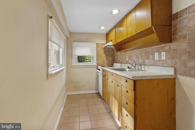 kitchen with backsplash, white range with electric stovetop, sink, and light tile patterned floors