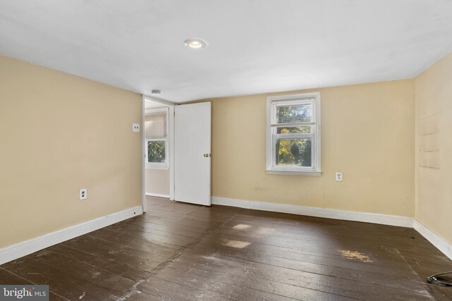 unfurnished room featuring dark hardwood / wood-style floors