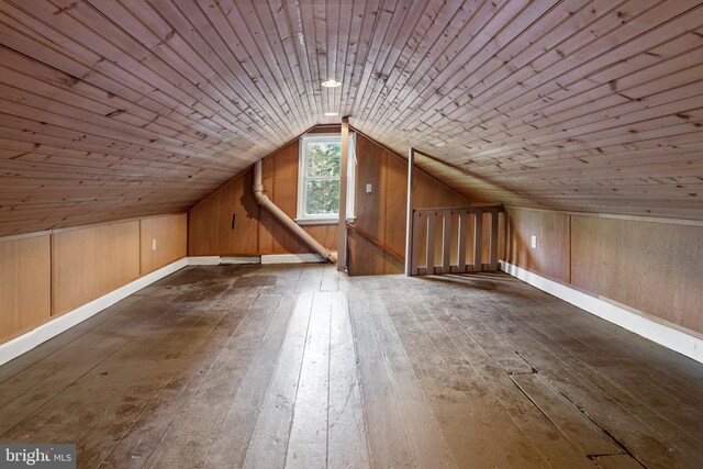 bonus room featuring lofted ceiling, wooden walls, wooden ceiling, and dark hardwood / wood-style floors