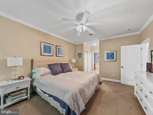 carpeted bedroom featuring crown molding, ceiling fan, and a closet