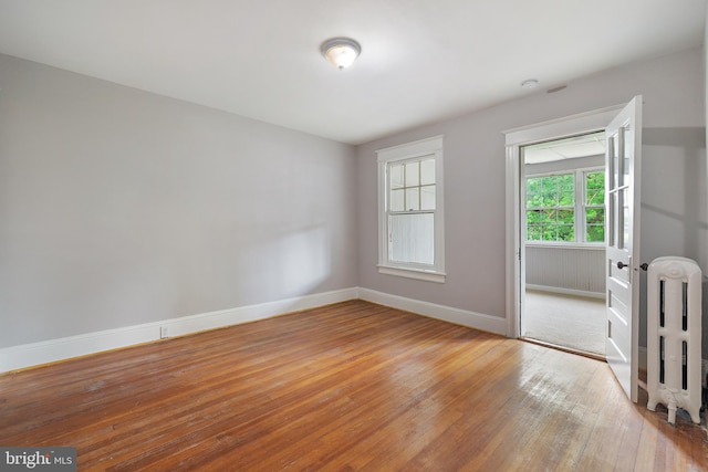 empty room with hardwood / wood-style flooring