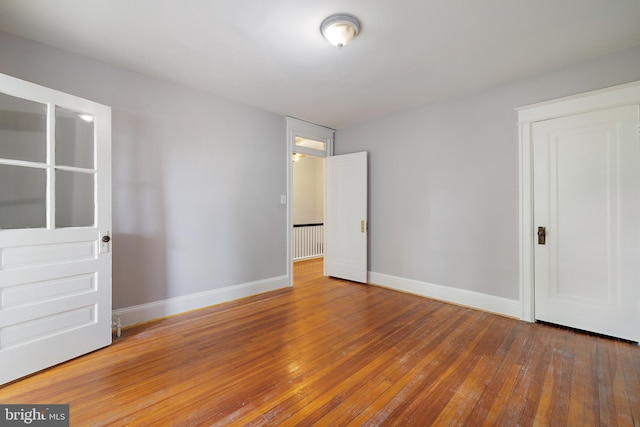 unfurnished bedroom with wood-type flooring