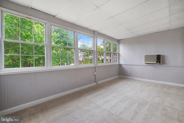 unfurnished sunroom featuring a drop ceiling and heating unit