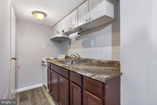 kitchen featuring dark wood-type flooring, dark stone countertops, sink, electric stove, and white cabinetry