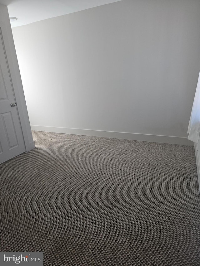 empty room with dark carpet