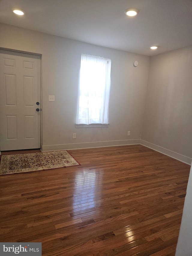 entryway with dark hardwood / wood-style flooring