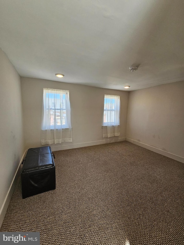 carpeted empty room featuring a healthy amount of sunlight