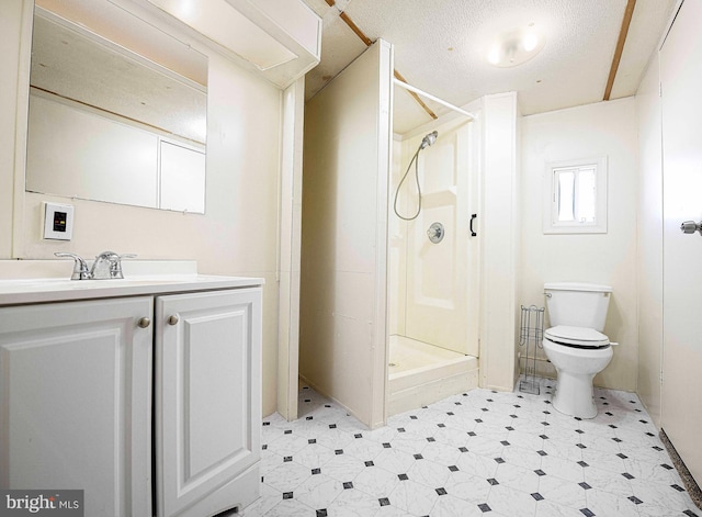 bathroom with vanity, a textured ceiling, toilet, and walk in shower