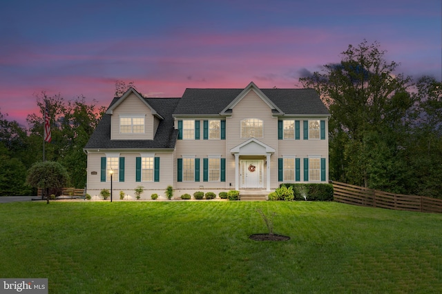 colonial-style house featuring a lawn