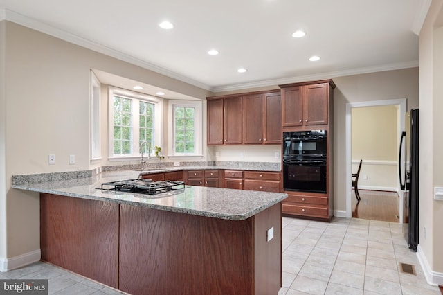 kitchen with light stone countertops, refrigerator, kitchen peninsula, crown molding, and light tile patterned floors