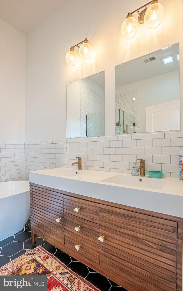 bathroom with tile patterned flooring, separate shower and tub, vanity, and tile walls