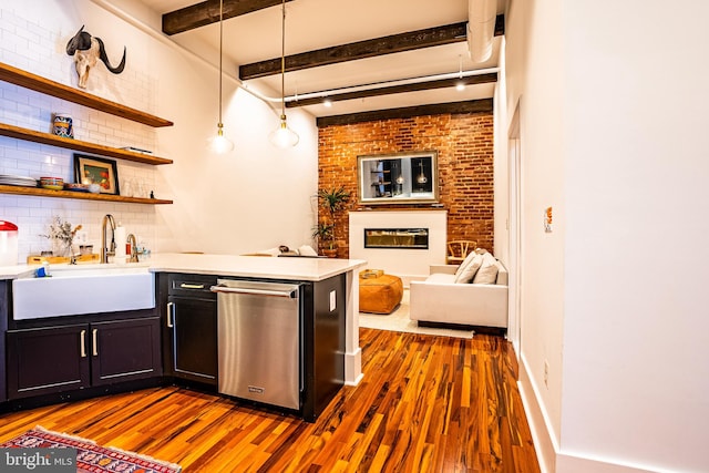 bar featuring beam ceiling, hanging light fixtures, sink, and dark hardwood / wood-style flooring