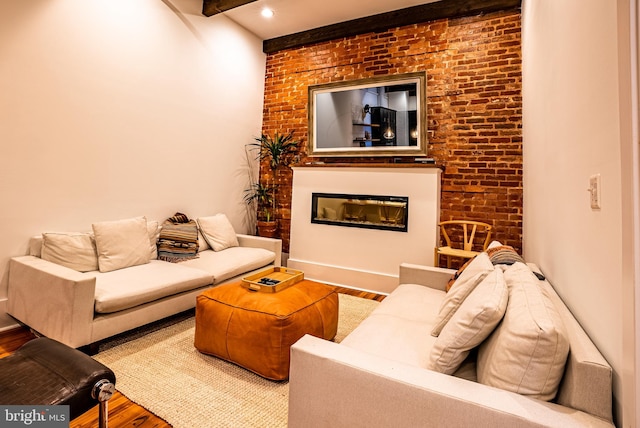 living room featuring brick wall and hardwood / wood-style floors