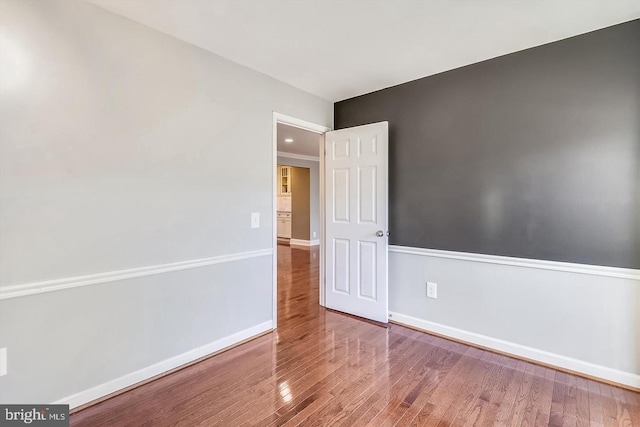 unfurnished room with hardwood / wood-style flooring