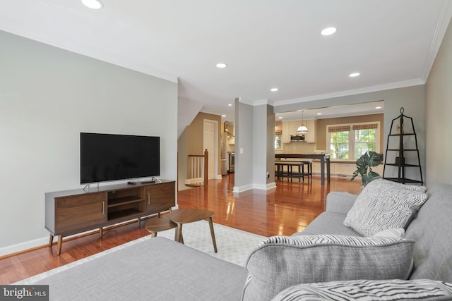 living room featuring crown molding and wood-type flooring