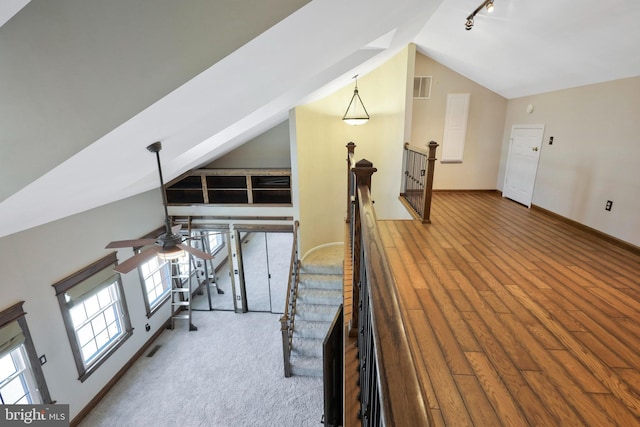 bonus room with hardwood / wood-style floors, vaulted ceiling, and ceiling fan