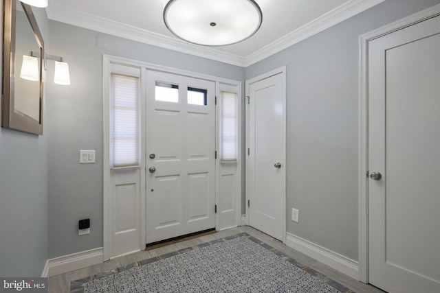 entrance foyer with hardwood / wood-style flooring and ornamental molding