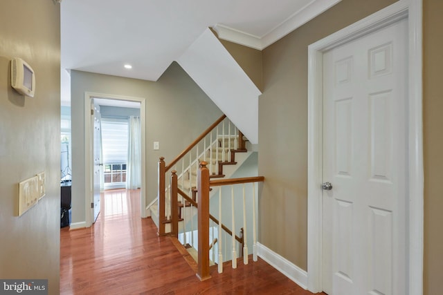 interior space with ornamental molding and hardwood / wood-style floors