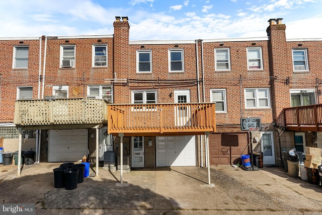 rear view of house featuring a garage