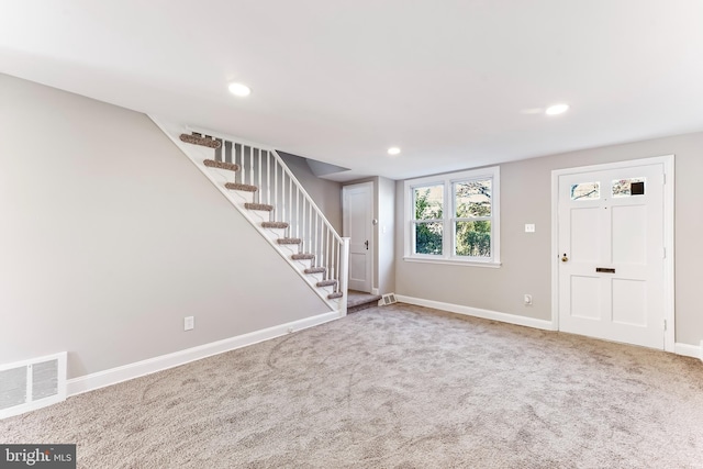 view of carpeted entrance foyer