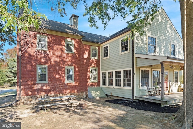 rear view of house featuring a wooden deck