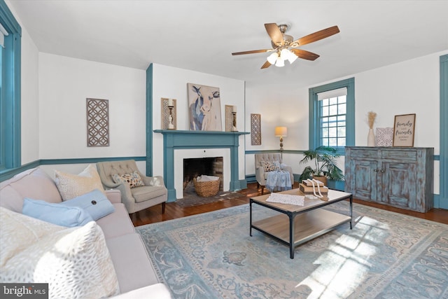 living room with ceiling fan and dark hardwood / wood-style flooring