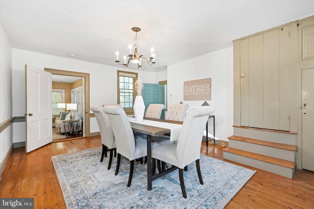 dining room featuring a notable chandelier and light hardwood / wood-style flooring