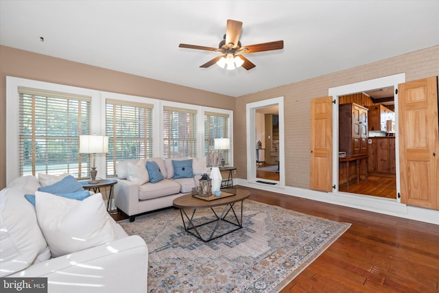 living room featuring hardwood / wood-style flooring and ceiling fan