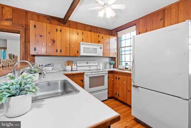 kitchen featuring ceiling fan, light hardwood / wood-style flooring, beamed ceiling, sink, and white appliances