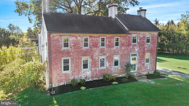 view of side of home featuring a yard