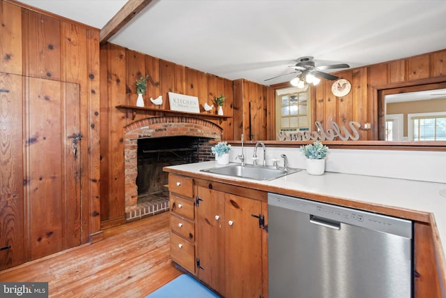 kitchen with dishwasher, wooden walls, light hardwood / wood-style flooring, sink, and ceiling fan