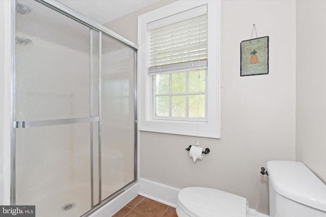 bathroom with toilet, an enclosed shower, and tile patterned floors