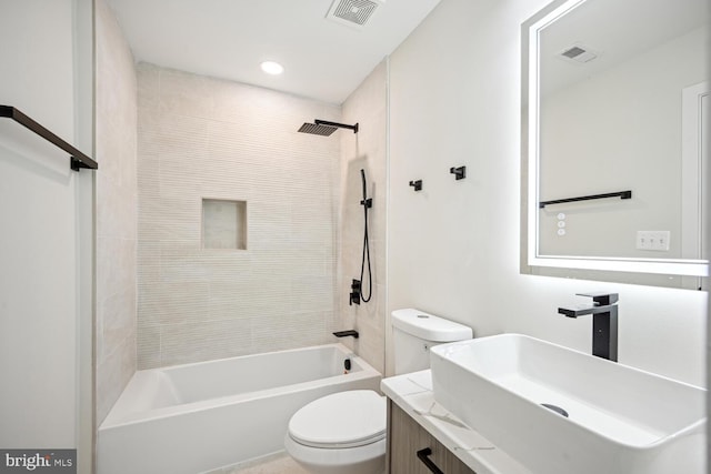 full bathroom featuring vanity, toilet, and tiled shower / bath combo