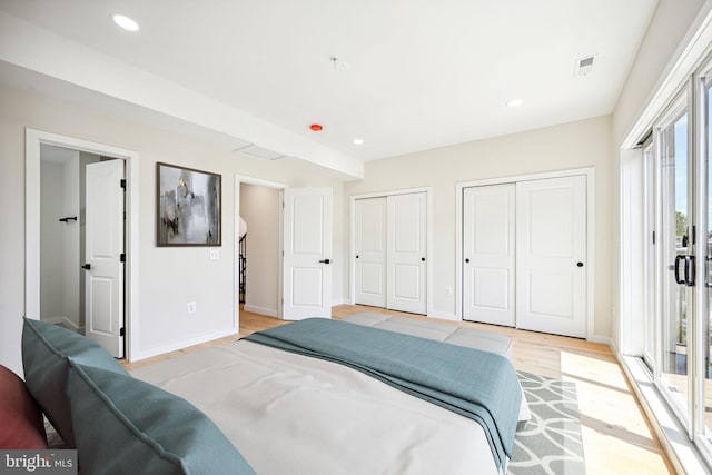 bedroom featuring multiple windows, access to exterior, and light wood-type flooring