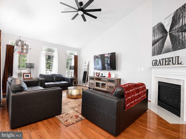 living room featuring ceiling fan, high vaulted ceiling, and hardwood / wood-style floors