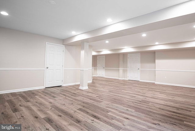 basement with hardwood / wood-style flooring