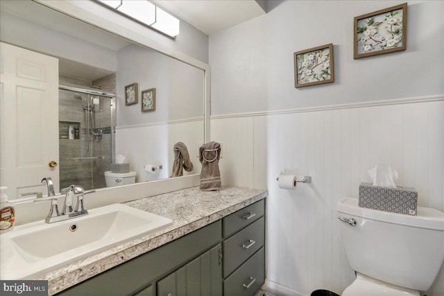 bathroom featuring walk in shower, vanity, and toilet