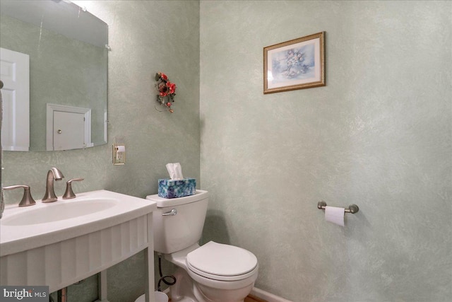 bathroom with sink and toilet