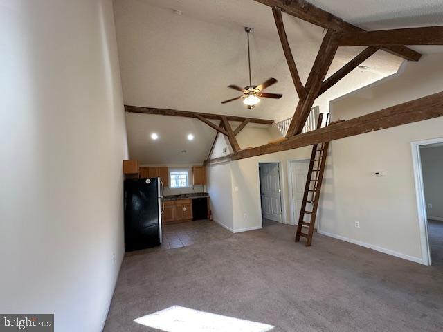 unfurnished living room featuring baseboards, light carpet, a ceiling fan, beamed ceiling, and high vaulted ceiling