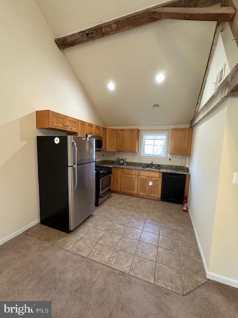 kitchen featuring high vaulted ceiling, beamed ceiling, a sink, and stainless steel appliances
