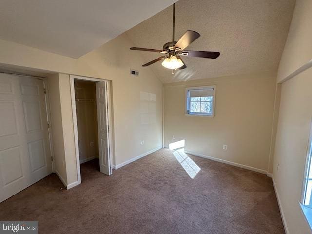 unfurnished bedroom with visible vents, baseboards, vaulted ceiling, and carpet floors