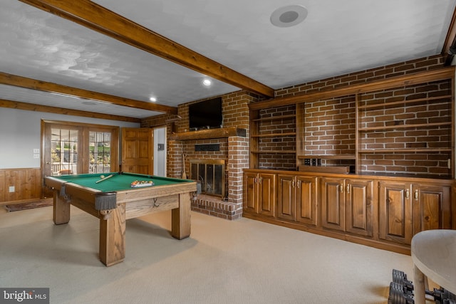 recreation room with beam ceiling, a brick fireplace, french doors, light colored carpet, and billiards