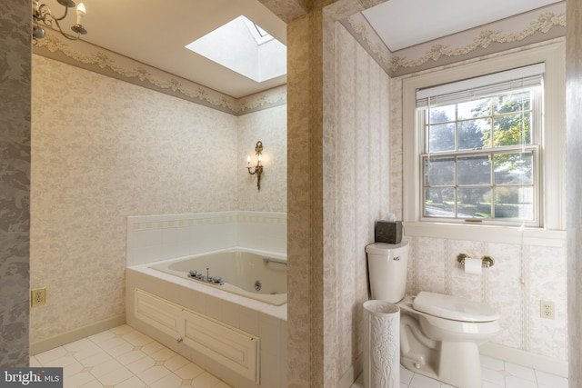 bathroom featuring a bathtub, tile patterned flooring, toilet, and a skylight