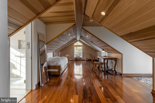 unfurnished bedroom with vaulted ceiling with beams, hardwood / wood-style flooring, and wooden ceiling