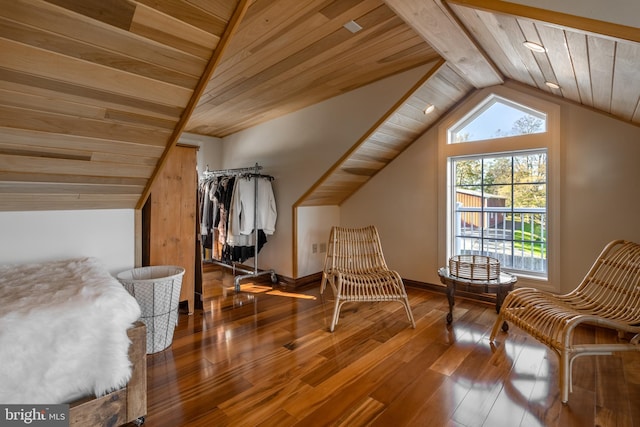 interior space featuring lofted ceiling with beams, hardwood / wood-style floors, and wooden ceiling