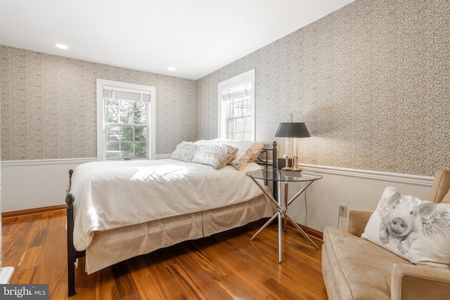 bedroom featuring multiple windows and wood-type flooring